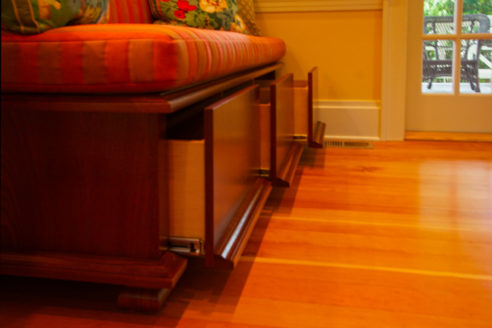 Deep drawers in custom mahogany built-in bench.