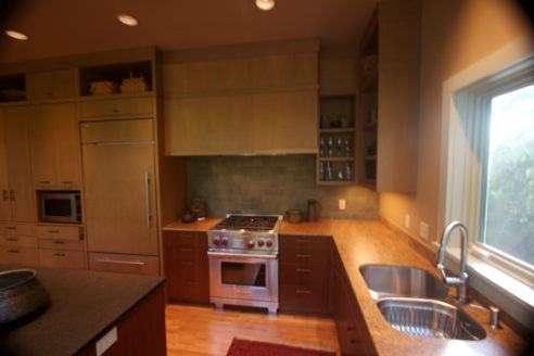 Wide View of Kitchen Area Featuring Sink & Stove